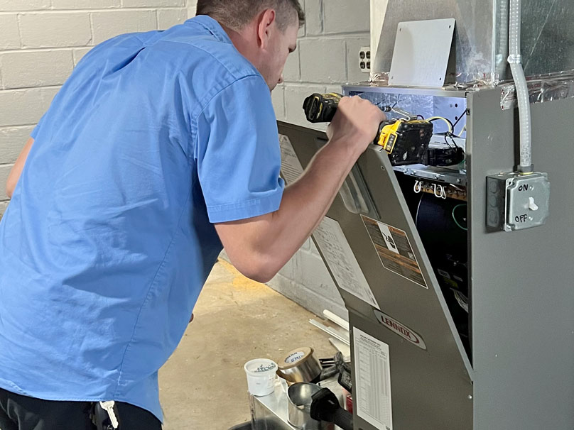 Perfect Air tech repairing a furnace