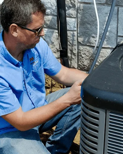 Technician servicing a residential heat pump in New Jersey.