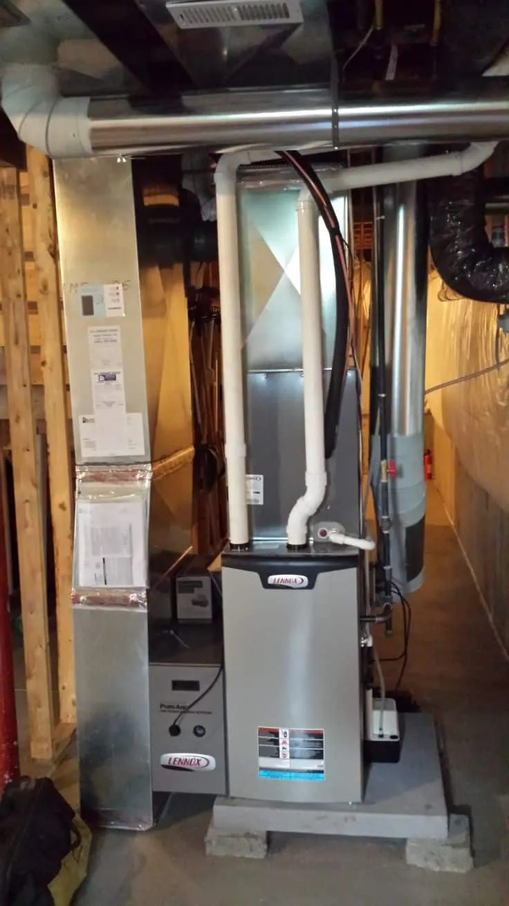 Technician servicing a furnace during an annual maintenance appointment.