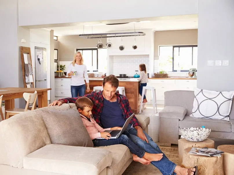 Family relaxing in a comfortable home served by a heat pump.
