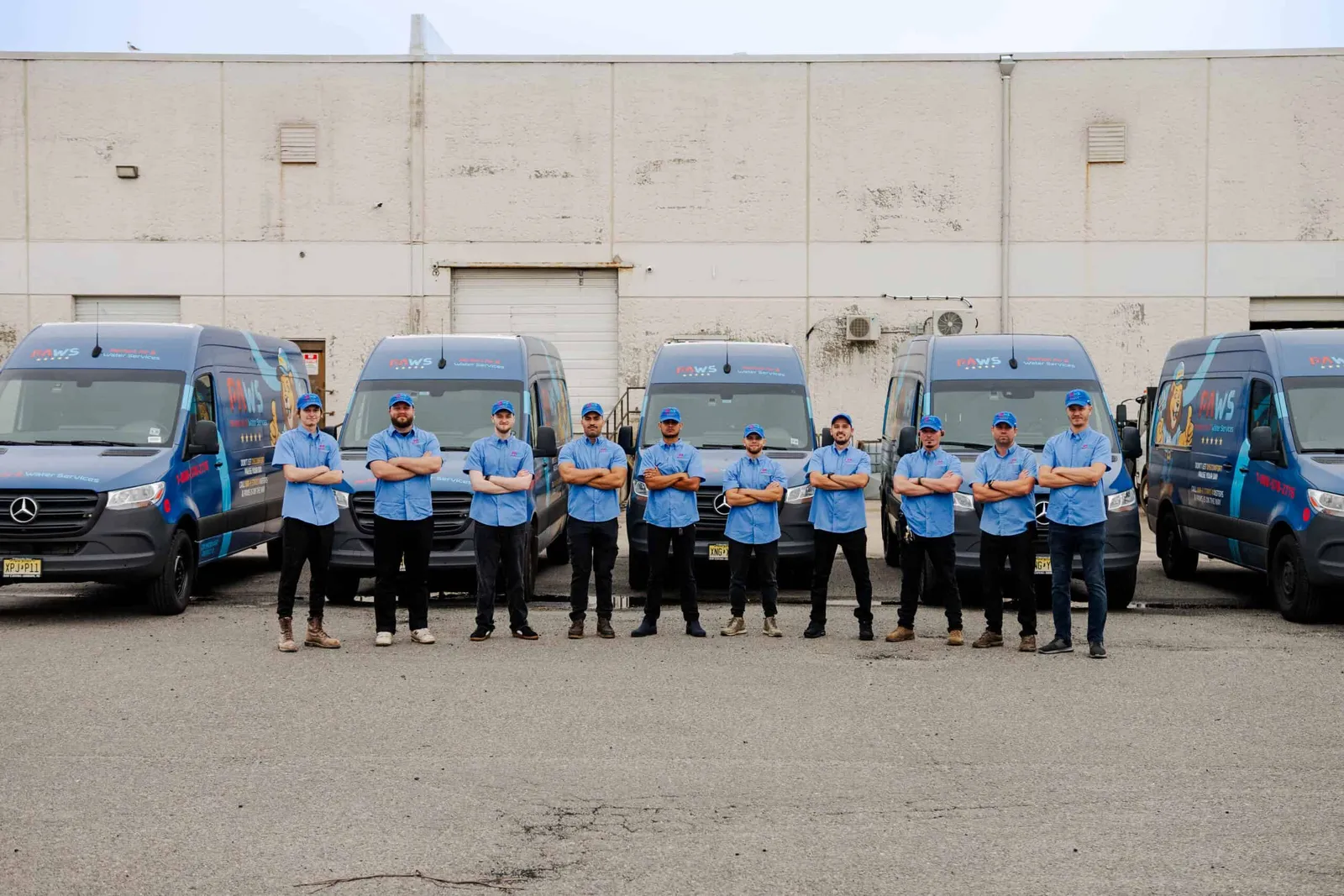 Perfect Air & Water team lined up in front of service vehicles