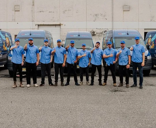 Perfect Air and Water technicians standing with service vans.