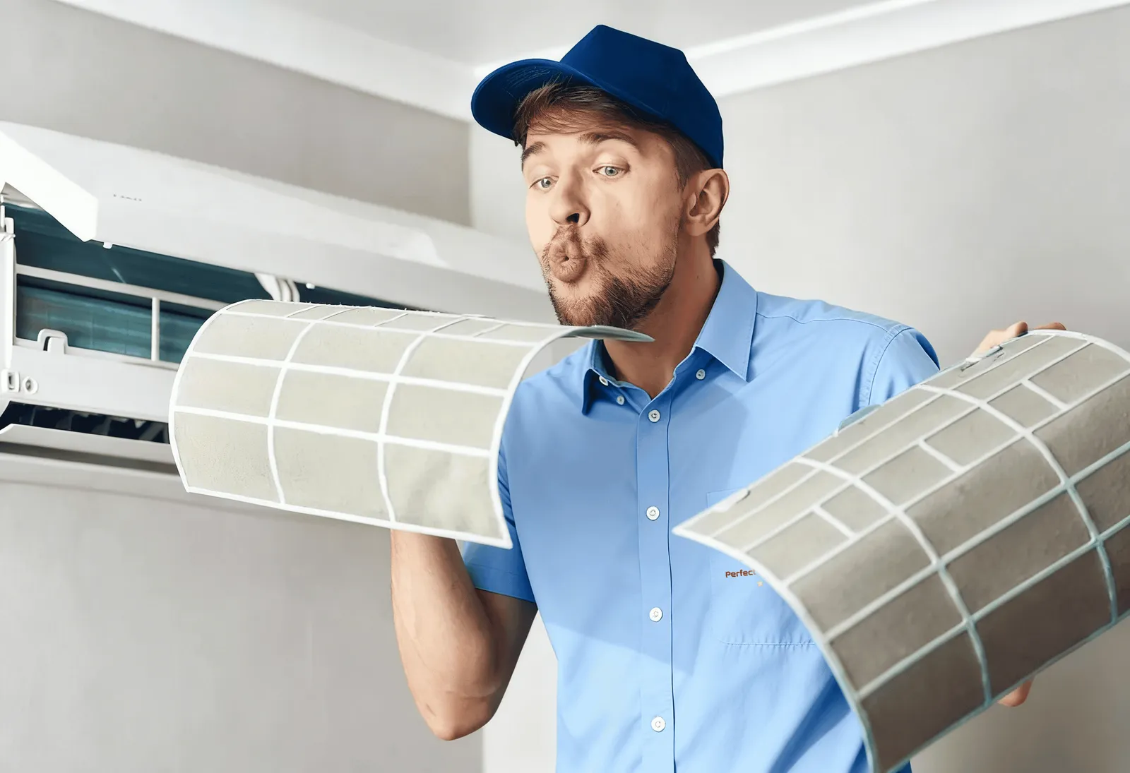 Technician adjusting a wall-mounted mini-split unit.
