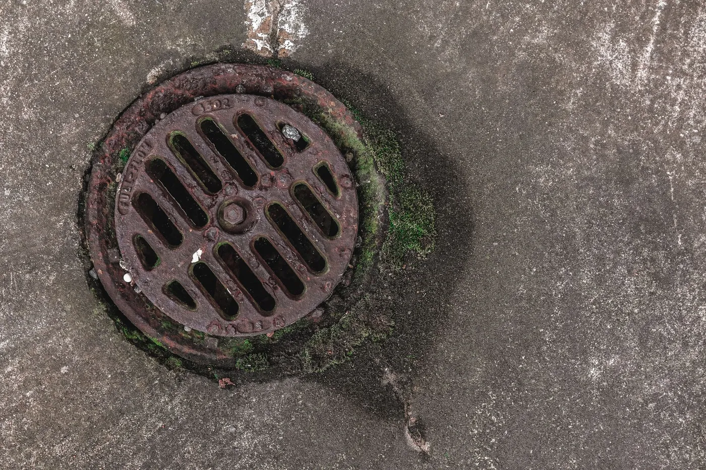 Basement floor drain and sewer cleanout in a New Jersey home.